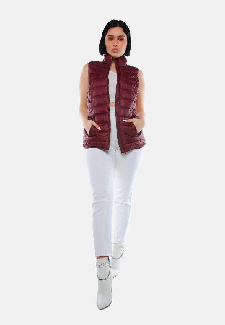 sleeveless puffer jacket in tangerine#color_burgundy