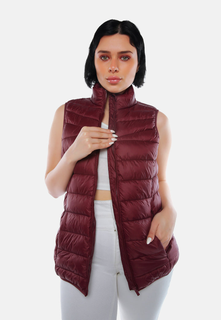 sleeveless puffer jacket in tangerine#color_burgundy