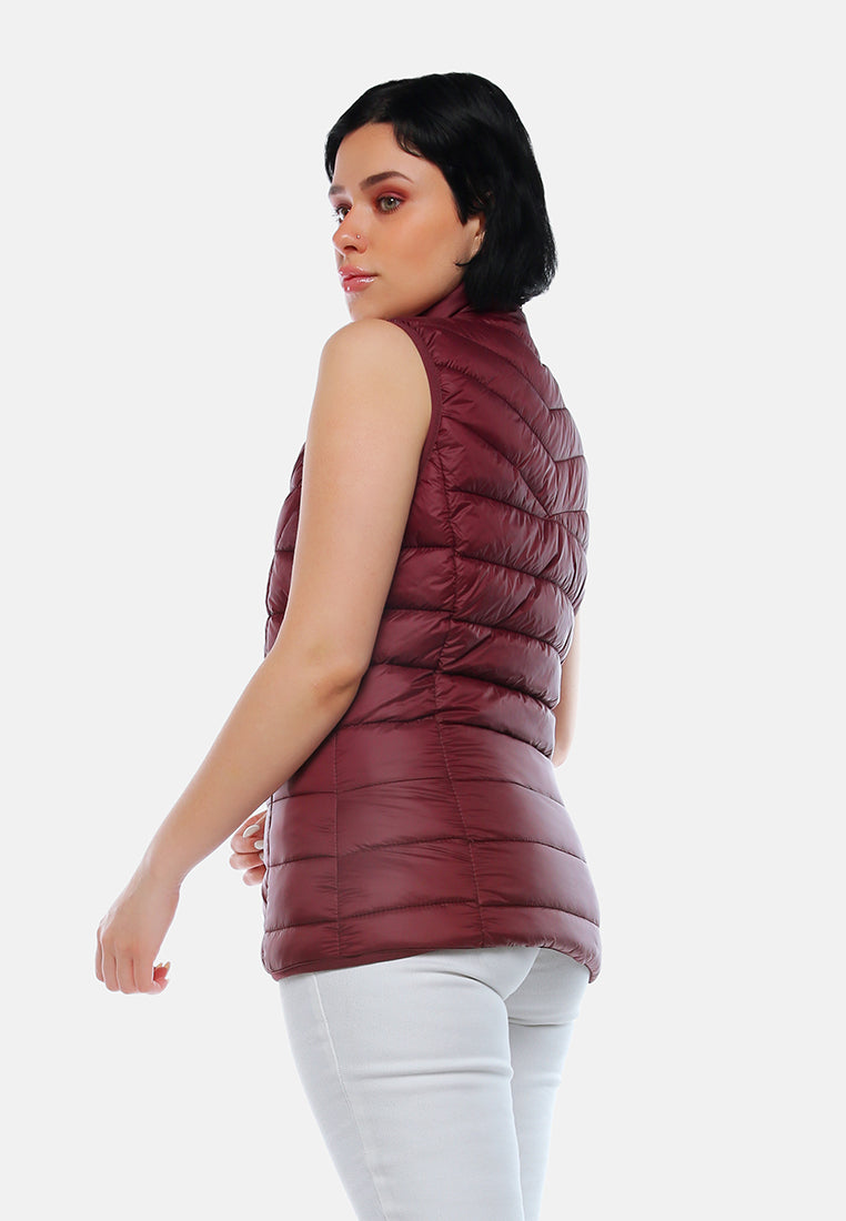 sleeveless puffer jacket in tangerine#color_burgundy