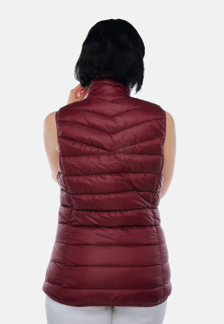 sleeveless puffer jacket in tangerine#color_burgundy