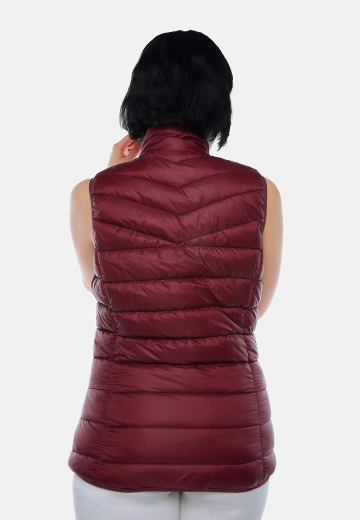 sleeveless puffer jacket in tangerine#color_burgundy