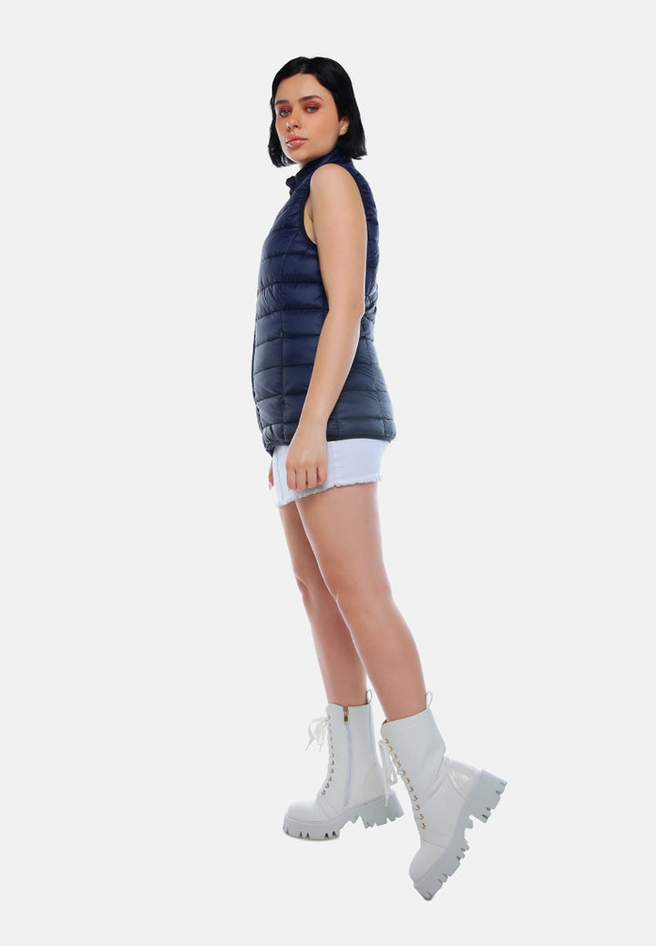 sleeveless puffer jacket in tangerine#color_navy
