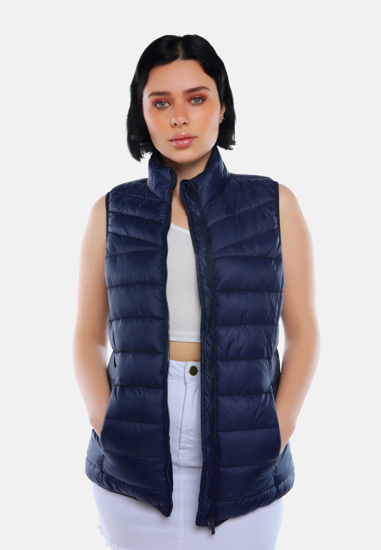sleeveless puffer jacket in tangerine#color_navy