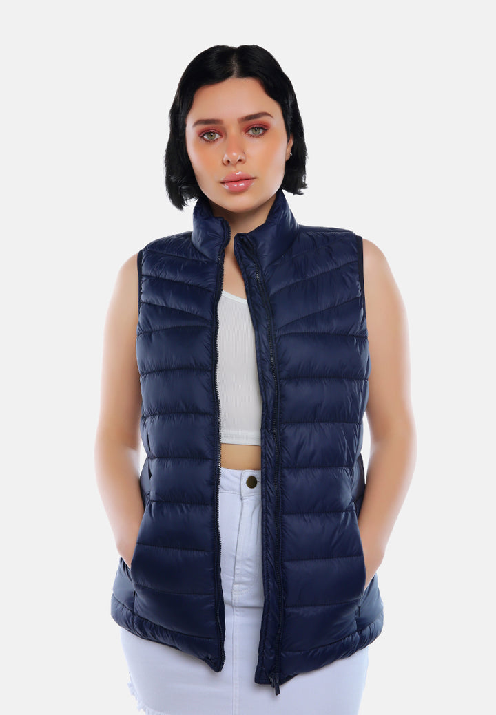 sleeveless puffer jacket in tangerine#color_navy