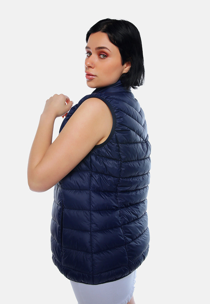 sleeveless puffer jacket in tangerine#color_navy