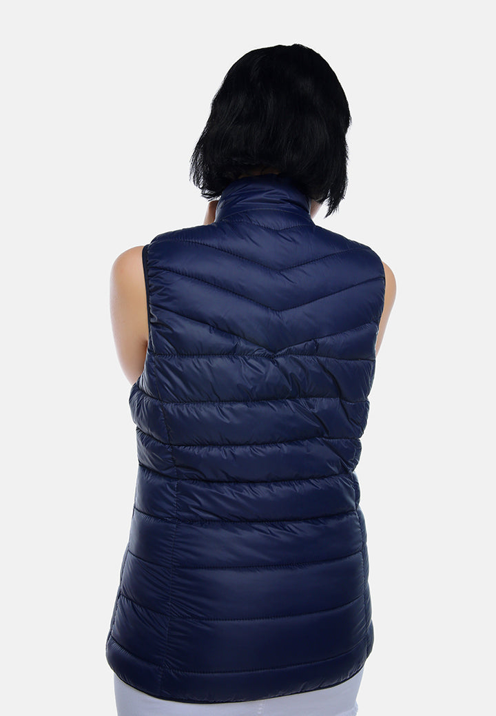 sleeveless puffer jacket in tangerine#color_navy